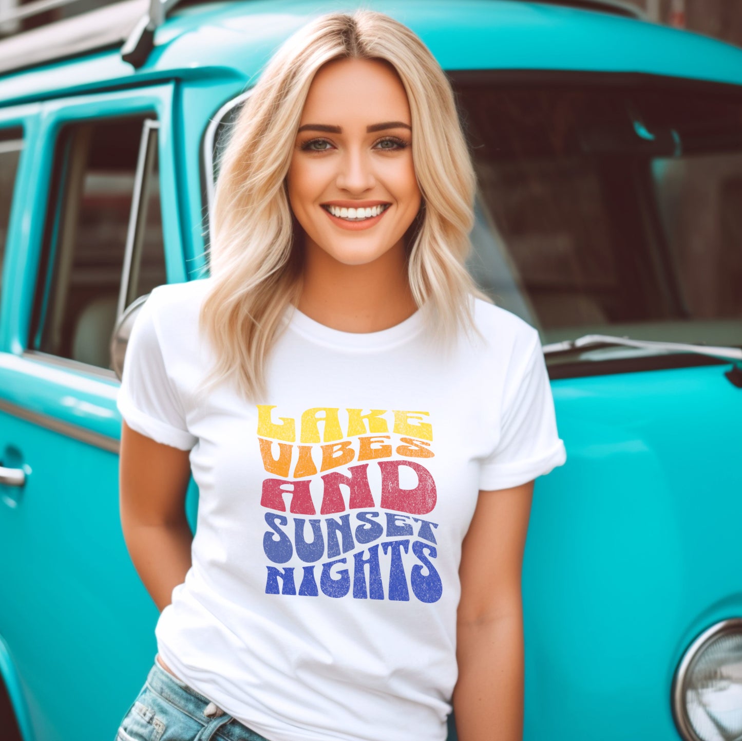 Person wearing Lake Vibes tee at lakeside during sunset