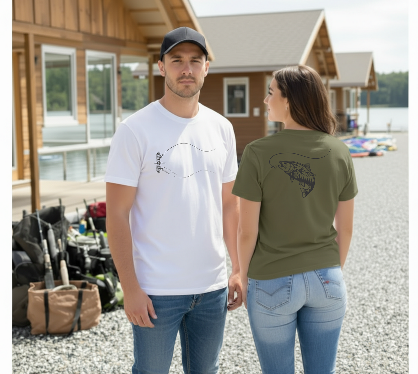 Man and woman standing outdoors by a cabin, wearing t-shirts with fish designs.