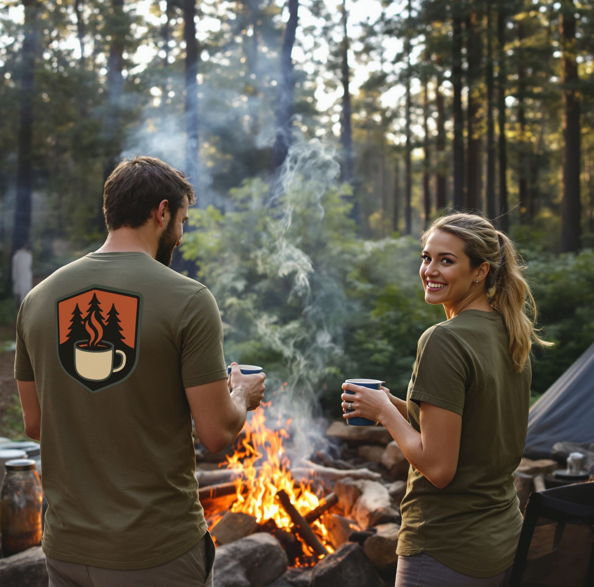 man and woman standing with campfire and coffee mugs